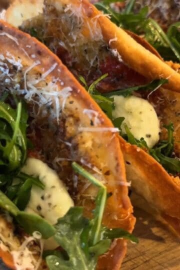 Chicken Parmesan Smash Tacos with crispy ground chicken, marinara sauce, melted fresh mozzarella, arugula, and basil