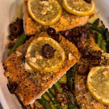 One Pan Roasted Salmon with Dates and Asparagus served on a sheet pan with fresh lemon, garlic, and olive oil. This healthy salmon dinner is easy to make, packed with flavor, and perfect for a quick weeknight meal.