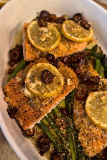 One Pan Roasted Salmon with Dates and Asparagus served on a sheet pan with fresh lemon, garlic, and olive oil. This healthy salmon dinner is easy to make, packed with flavor, and perfect for a quick weeknight meal.