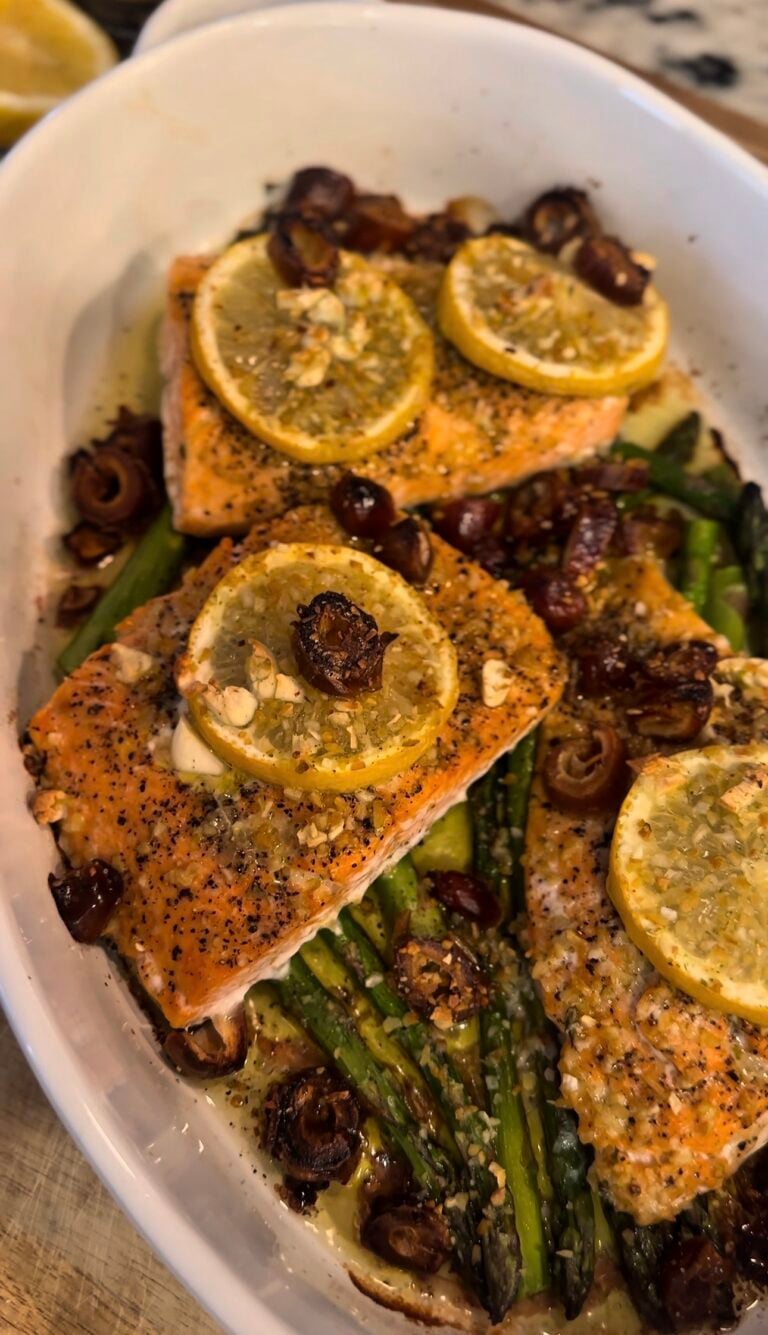 One Pan Roasted Salmon with Dates and Asparagus served on a sheet pan with fresh lemon, garlic, and olive oil. This healthy salmon dinner is easy to make, packed with flavor, and perfect for a quick weeknight meal.