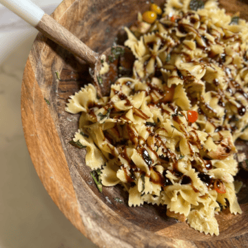 Chicken Bruschetta Pasta topped with fresh basil and balsamic glaze, an easy garden-to-table summer dinner recipe made with tomatoes, chicken, and pasta.