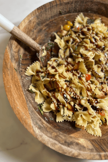 Chicken Bruschetta Pasta topped with fresh basil and balsamic glaze, an easy garden-to-table summer dinner recipe made with tomatoes, chicken, and pasta.