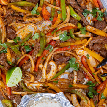 Sheet pan steak fajitas made with tender skirt steak, colorful bell peppers, and onions roasted until lightly charred and served with warm tortillas for an easy weeknight Tex-Mex dinner.