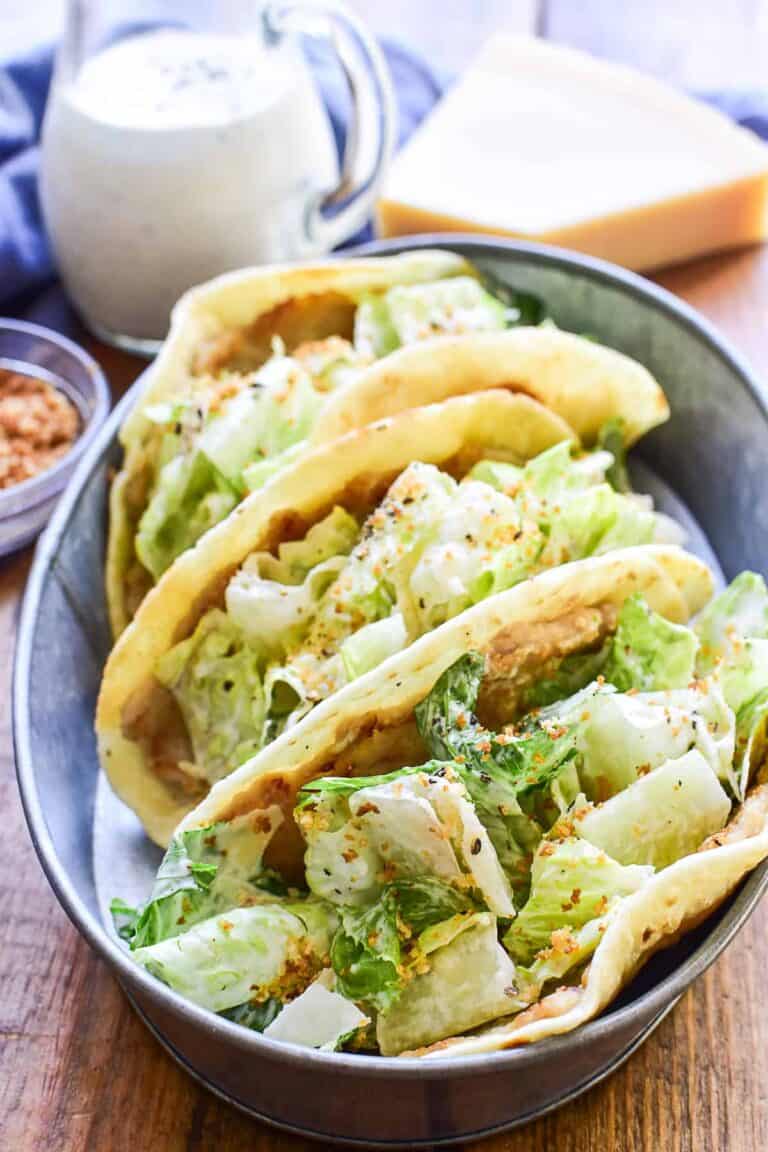 Chicken Caesar Smash Tacos made with seasoned ground chicken cooked on crispy pita bread and topped with fresh Caesar salad. This easy 20-minute dinner combines the flavors of chicken Caesar salad and smash tacos for a quick weeknight meal.