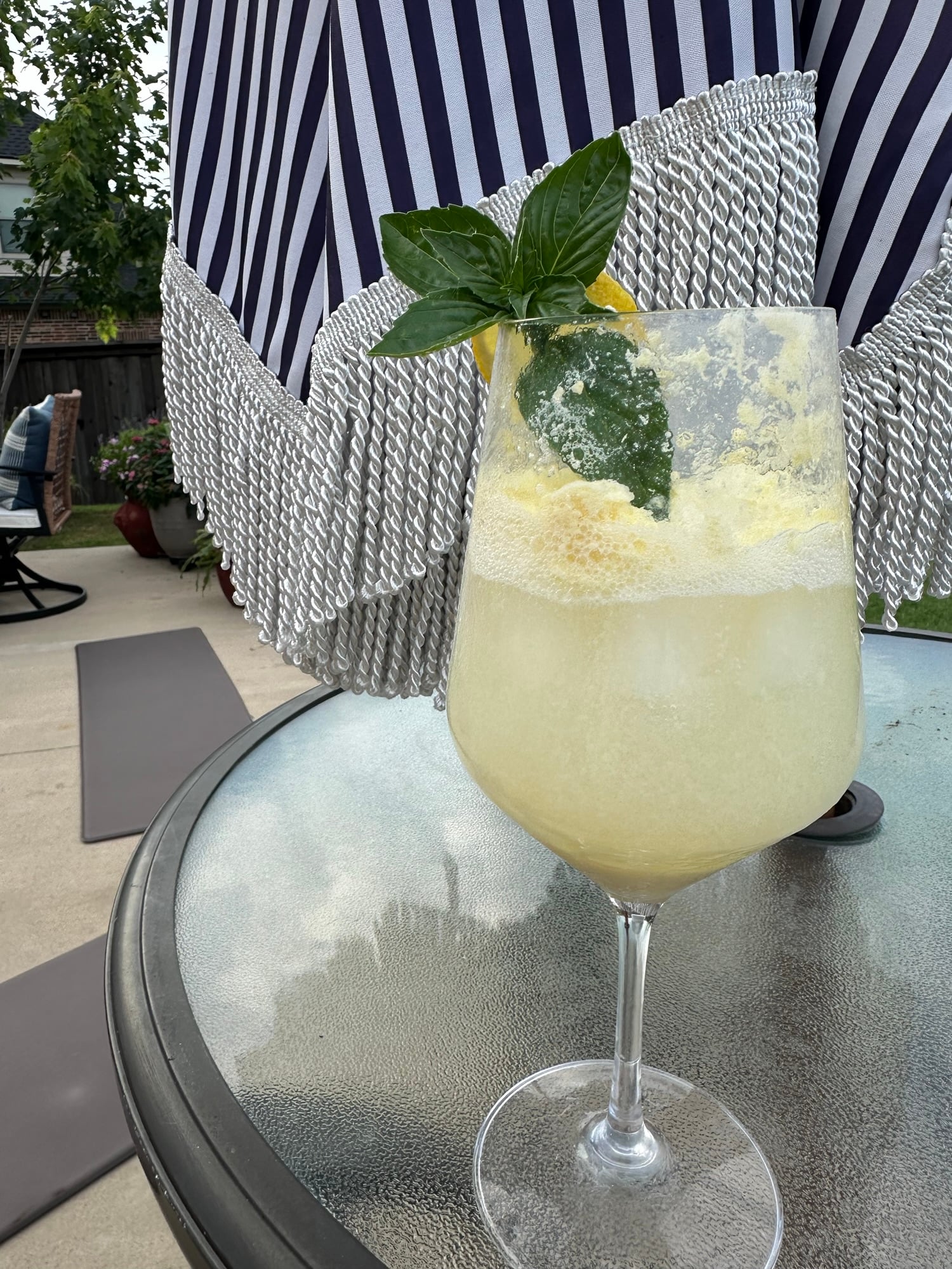 A refreshing Limoncello Spritz made with creamy limoncello, prosecco, and club soda, garnished with fresh mint and a lemon slice over ice.