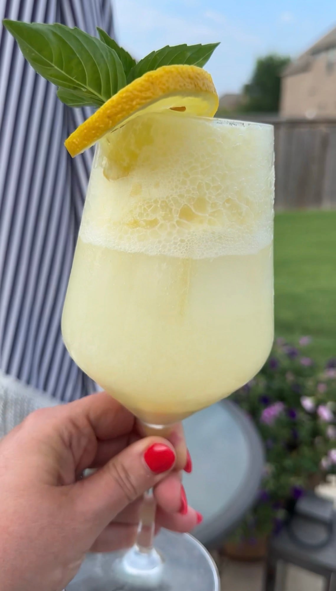 A refreshing Limoncello Spritz made with creamy limoncello, prosecco, and club soda, garnished with fresh mint and a lemon slice over ice.
