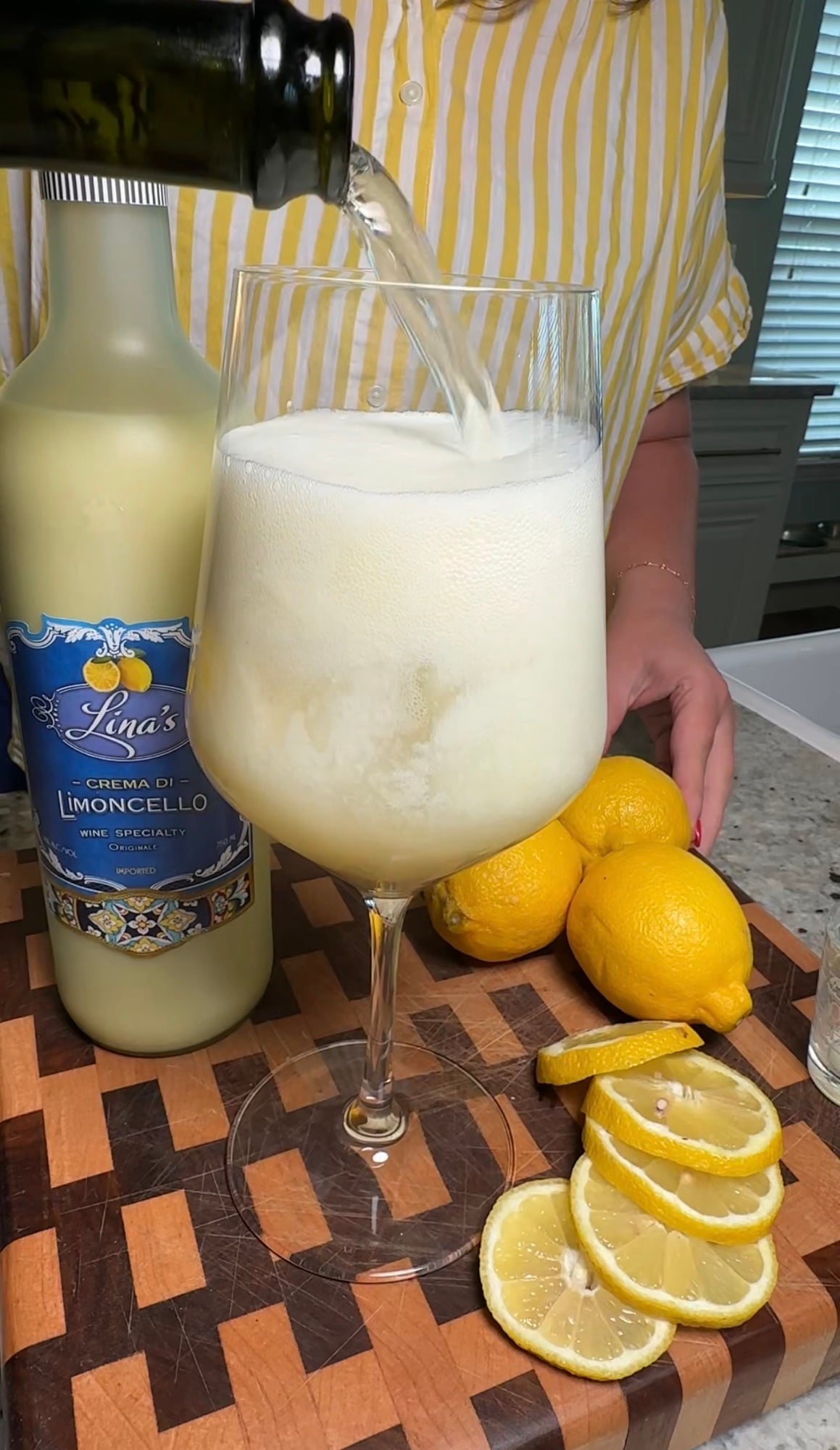 A refreshing Limoncello Spritz made with creamy limoncello, prosecco, and club soda, garnished with fresh mint and a lemon slice over ice.