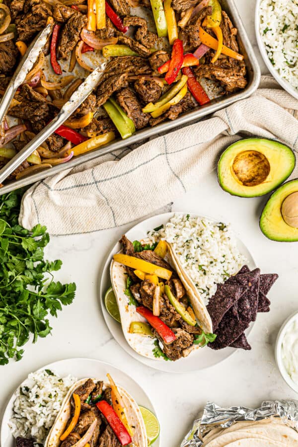 Sheet Pan Steak Fajitas made with tender skirt steak, colorful bell peppers, and onions roasted on a baking sheet and served with warm tortillas. This easy steak fajitas recipe delivers bold Tex-Mex flavor without a grill, making it the perfect weeknight steak dinner.