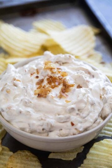 3 Ingredient Chipotle Onion Dip made with sour cream, onion soup mix, and smoky chipotle peppers in adobo, served with chips.