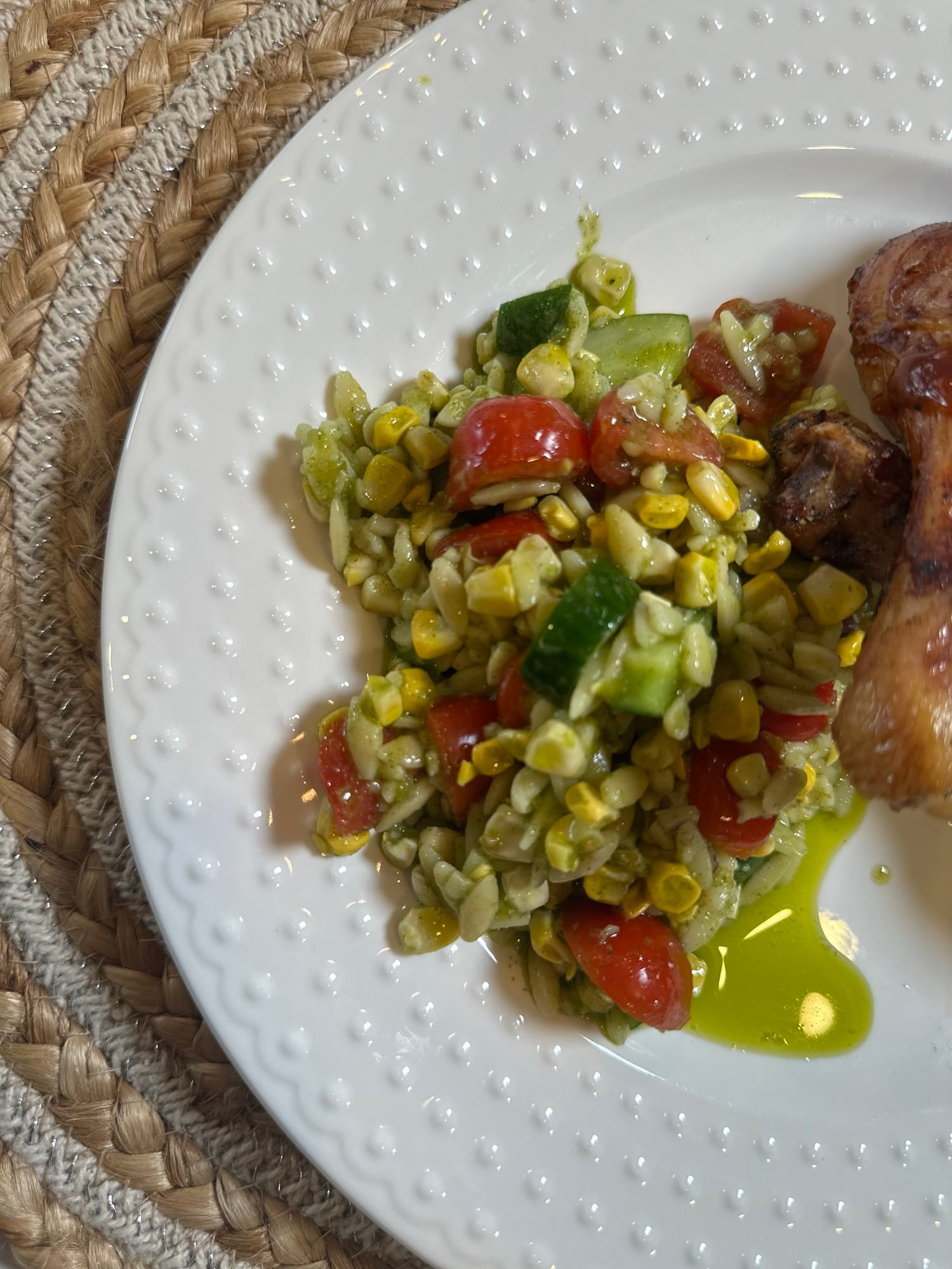 Corn & Tomato Orzo Pasta Salad with grilled corn, cherry tomatoes, cucumber, red onion, and garlic cilantro dressing served in a white bowl.