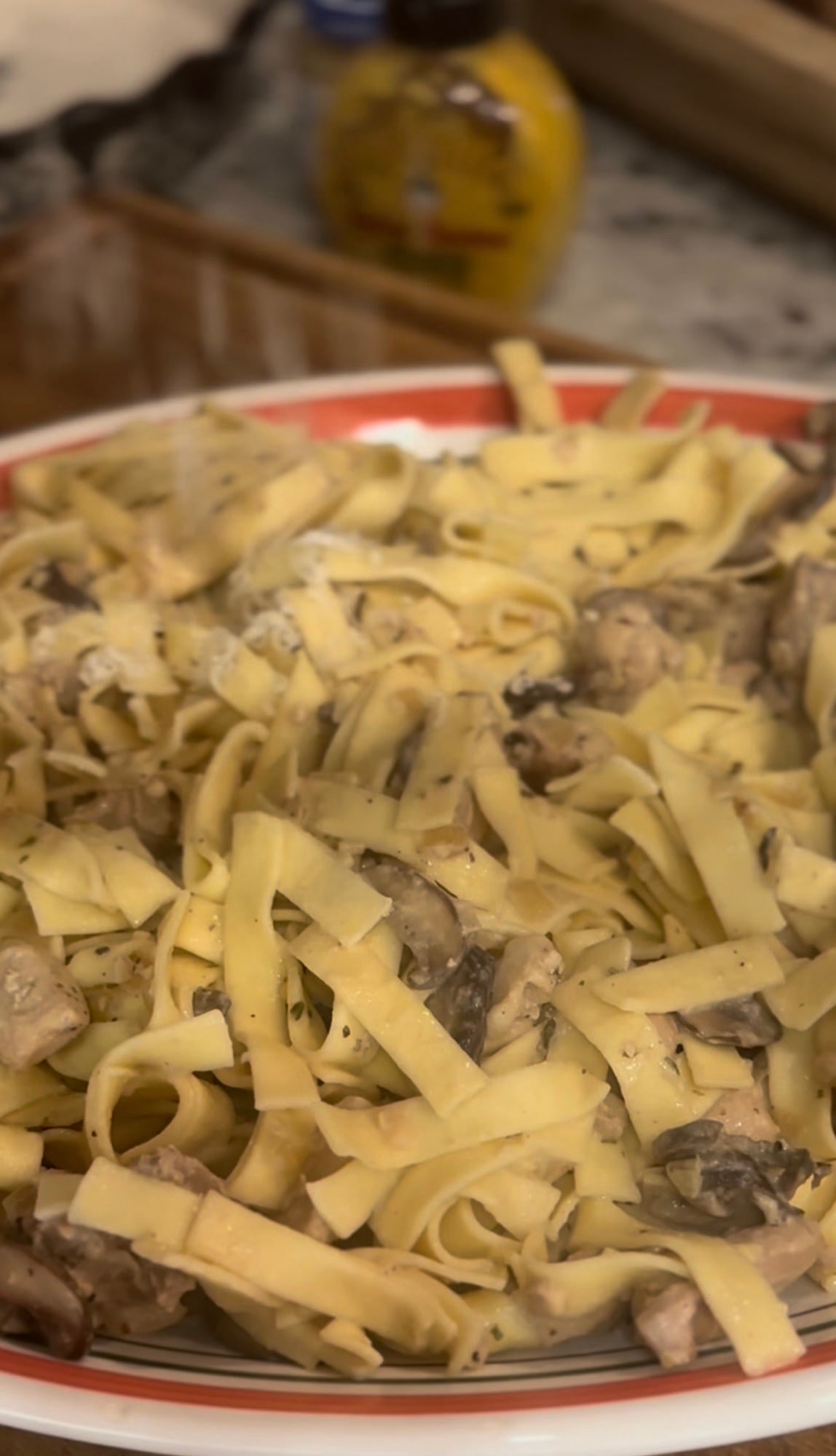 Creamy Boursin Chicken Stroganoff served over egg noodles with mushrooms and fresh parsley.