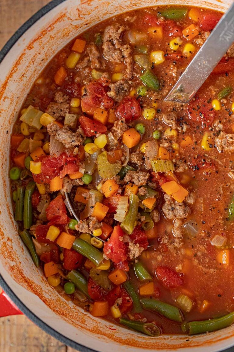 Bowl of hearty veggie beef soup made with ground beef, vegetables, and V8 tomato juice