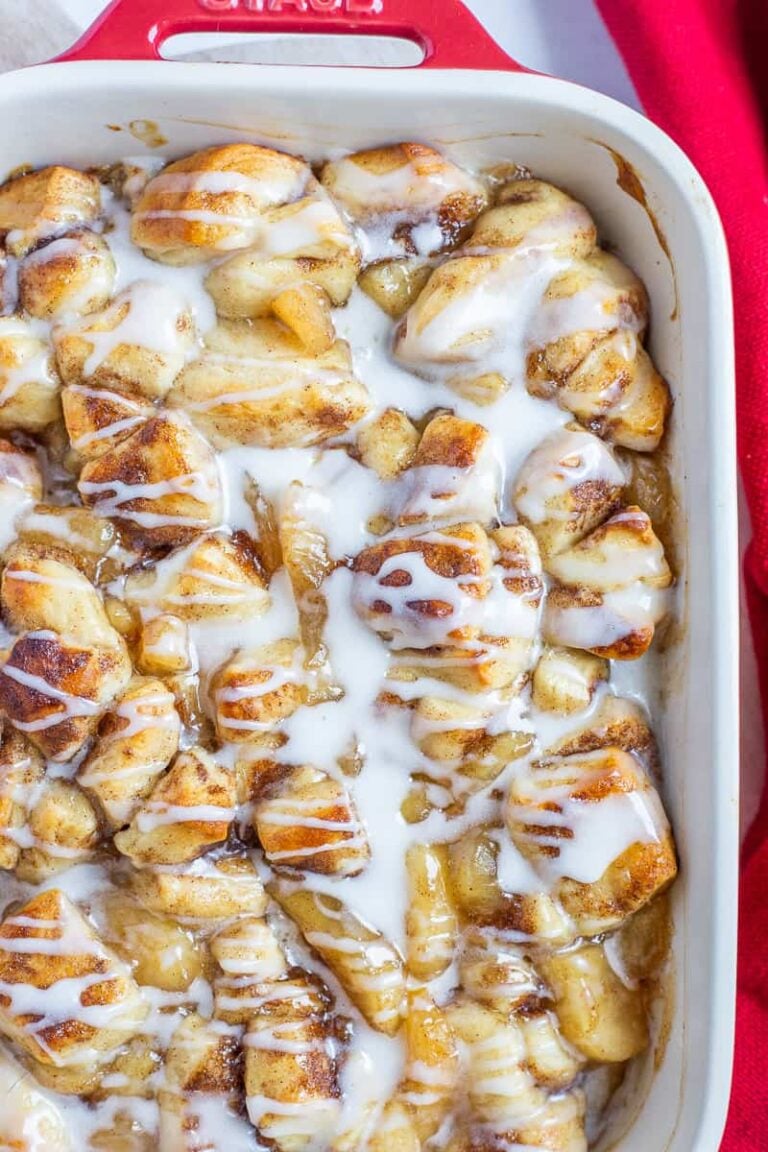 2-ingredient apple cobbler made with apple pie filling and cinnamon rolls, baked until golden and topped with cinnamon roll icing