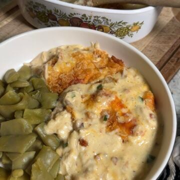 Neiman Marcus chicken casserole in a white 9x13 dish with a golden Ritz cracker topping and crumbled bacon