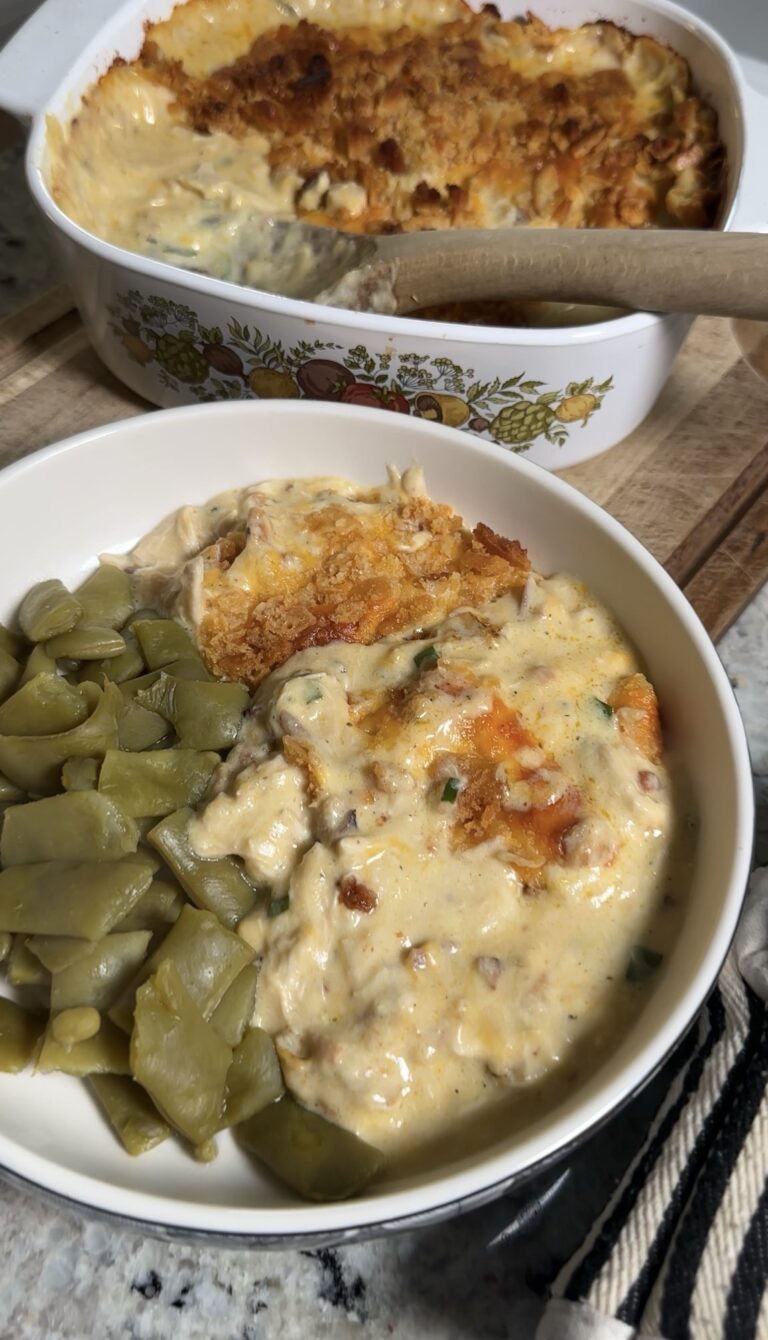 Neiman Marcus chicken casserole in a white 9x13 dish with a golden Ritz cracker topping and crumbled bacon