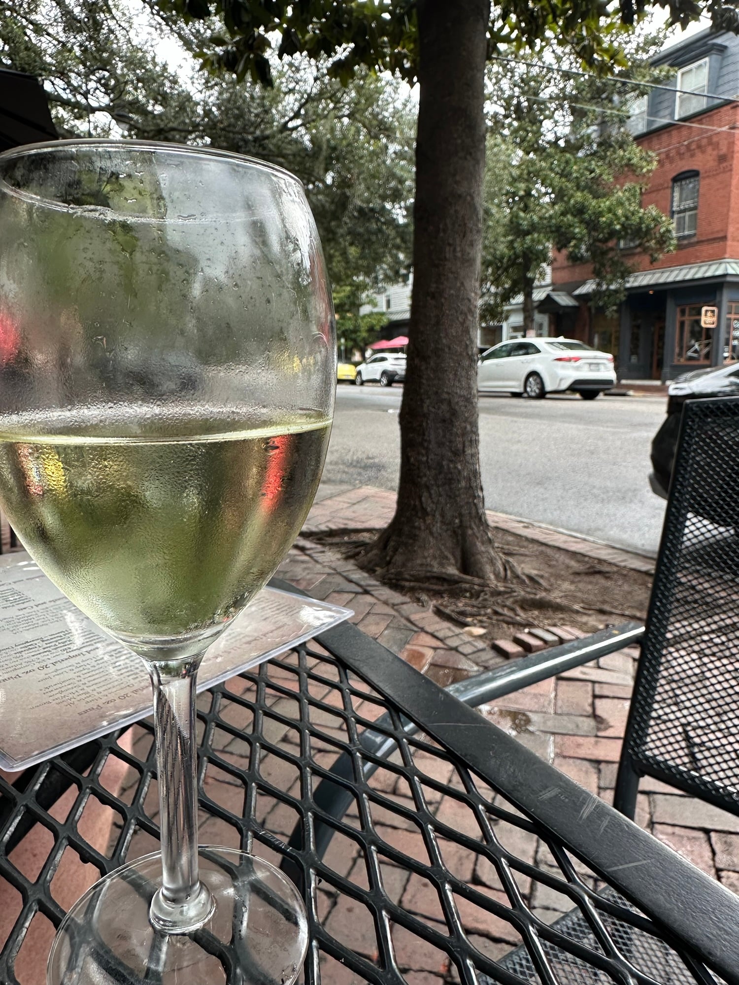 Glass of wine on a table at Six Pence Pub in downtown Savannah