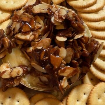 Brown Sugar Almond Baked Brie topped with buttery caramelized almonds and served with Ritz crackers