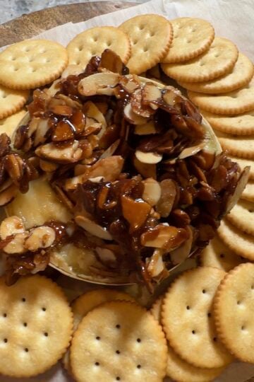 Brown Sugar Almond Baked Brie topped with buttery caramelized almonds and served with Ritz crackers