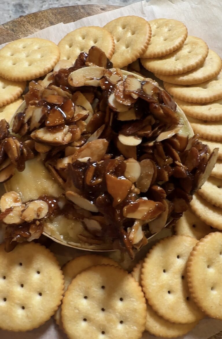 Brown Sugar Almond Baked Brie topped with buttery caramelized almonds and served with Ritz crackers