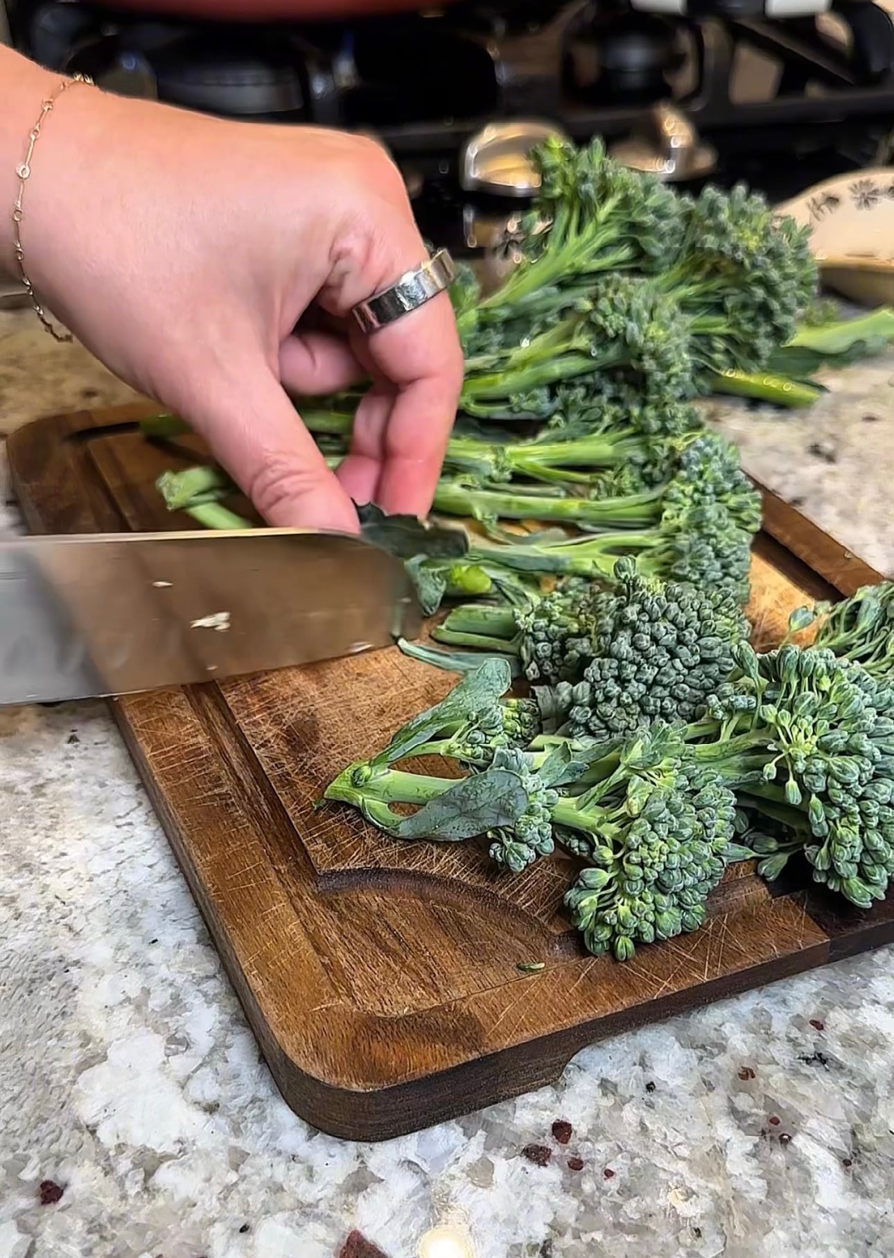 Fresh broccoli rabe being trimmed and cut into pieces for orecchiette pasta.