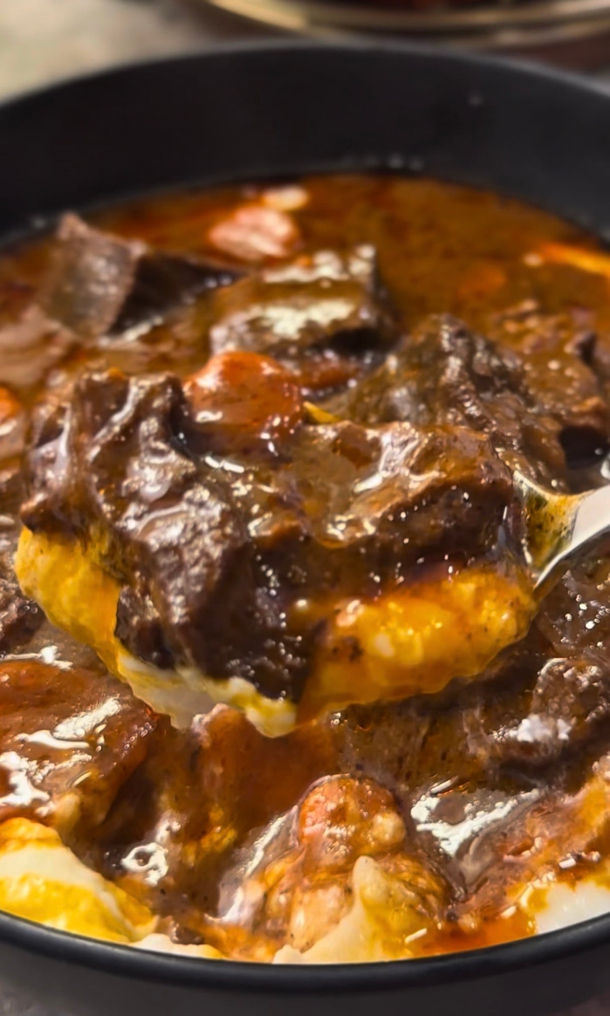 Julia Child-inspired Beef Bourguignon served over creamy mashed potatoes with tender beef, carrots and mushrooms