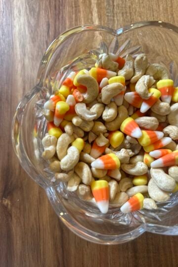 Candy corn and lightly salted cashews mixed together in a serving bowl.