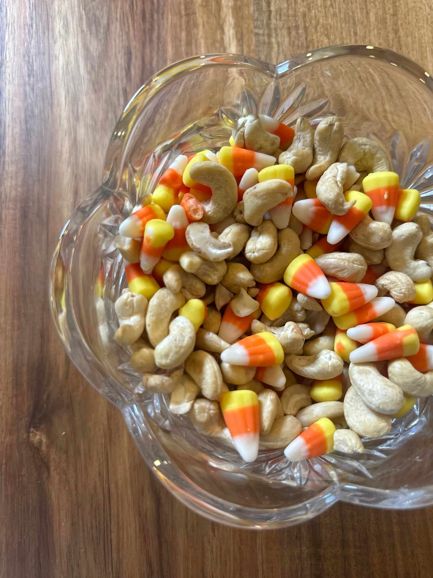 Candy corn and lightly salted cashews mixed together in a serving bowl.
