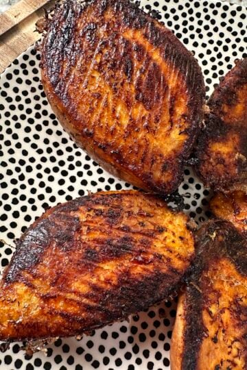 Baked sweet potato halves with a golden butter and Parmesan crust.