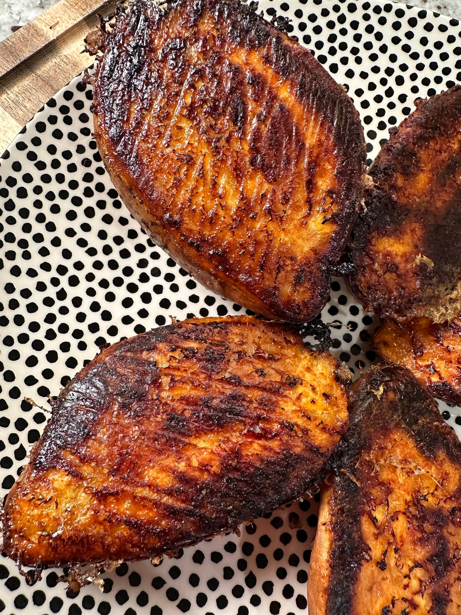 Baked sweet potato halves with a golden butter and Parmesan crust.